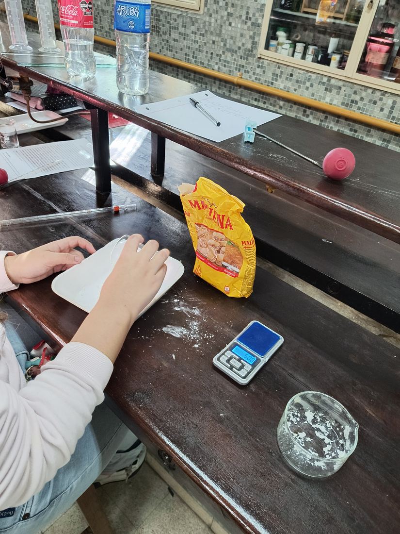 Medición de masa con balanza en una práctica de laboratorio.